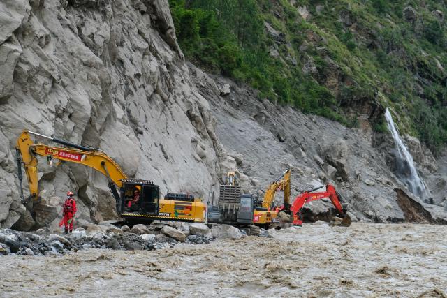 Workers use excavators to clear debris and rebuild the mudslide-damaged road which leads to Gyirong Port in Gyirong County, in China’s western Tibet region on August 30, 2026. (Photo by CNS / AFP) / China OUT