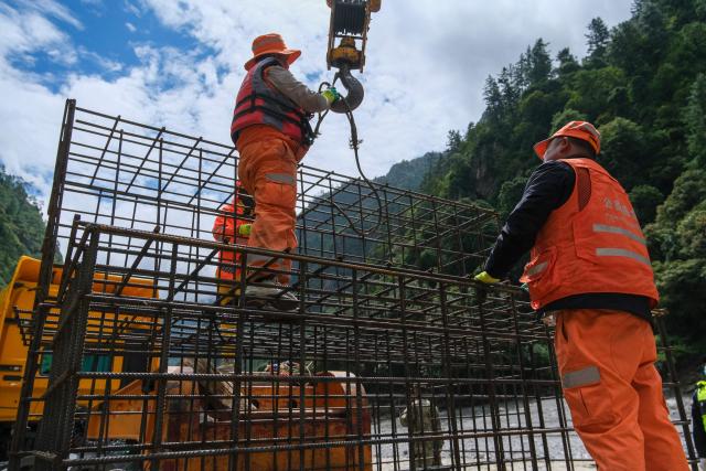 Workers assemble steel reinforcement cages to be used for stabilizing the mudslide-damaged road which leads to Gyirong Port in Gyirong County, in China’s western Tibet region on August 30, 2026. (Photo by CNS / AFP) / China OUT
