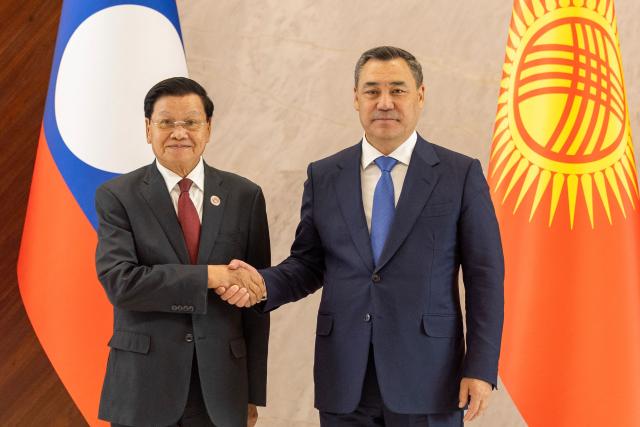 Kyrgyzstan's President Sadyr Japarov (R) and Laotian President Thongloun Sisoulith shake hands during the expanded meeting of the Council of Heads of State of the Shanghai Cooperation Organisation (SCO) member states in Bishkek on August 31, 2026. (Photo by BYAMBA-OCHIR / AFP)