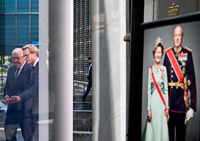 German President Frank-Walter Steinmeier (L) arrives to sign a book of condolence for late Norwegian King Harald V alongside Norways Deputy Ambassador to Germany Johan Loovv as a picture of a photograph of late Norwegian King Harald V and Queen Sonja is on display at the Royal Norwegian Embassy in Berlin, on August 31, 2026. King Harald V of Norway, who died on August 28, 2026 aged 89, remained a unifying figure in his country until the very end, a pillar of stability amid a string of family scandals that tarnished the final years of his reign. (Photo by Tobias SCHWARZ / AFP)