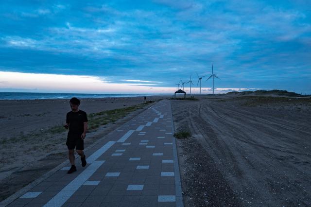 A man walks at Nikkawahama Beach in Kamisu city, Ibaraki prefecture on August 31, 2026. (Photo by Philip FONG / AFP)