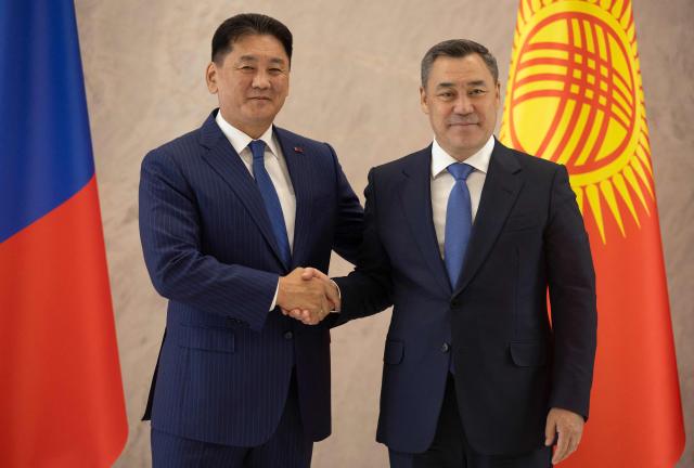 Mongolia's President Ukhnaagiin Khurelsukh (L) is greeted by Kyrgyzstan's President Sadyr Japarov during the expanded meeting of the Council of Heads of State of the Shanghai Cooperation Organisation (SCO) member states at the Presidential Palace in Bishkek, Kyrgyzstan on August 31, 2026. (Photo by BYAMBASUREN BYAMBA-OCHIR / AFP)