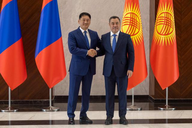 Mongolia's President Ukhnaagiin Khurelsukh (L) is greeted by Kyrgyzstan's President Sadyr Japarov during the expanded meeting of the Council of Heads of State of the Shanghai Cooperation Organisation (SCO) member states at the Presidential Palace in Bishkek, Kyrgyzstan on August 31, 2026. (Photo by BYAMBASUREN BYAMBA-OCHIR / AFP)