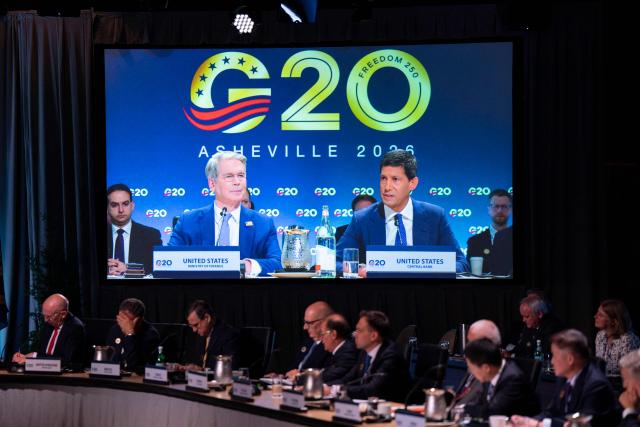 (L-R) US Secretary of Treasury Scott Bessent and US Federal Reserve chairman Kevin Warsh are displayed on a TV screen as they speak during the G20 Finance Ministers and Central Bank Governors’ meeting in Asheville, North Carolina, on August 31, 2026. Finance leaders from the Group of 20 major economies open talks Monday at a US-hosted gathering, with the Trump administration seeking to escalate economic pressure on Iran amid a renewed exchange of fire with Tehran. (Photo by Allison Joyce / AFP)