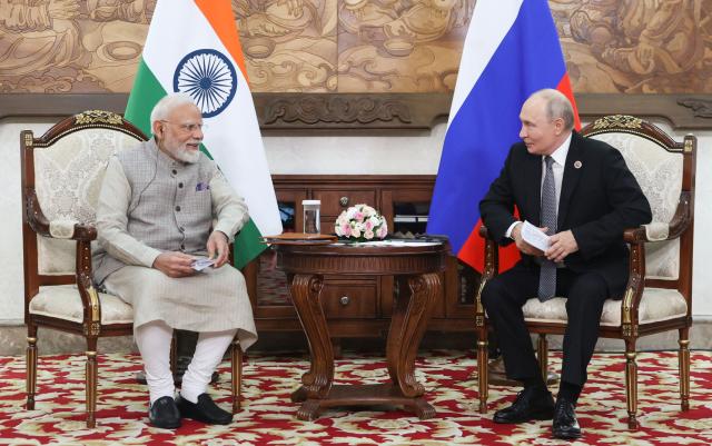 In this pool photograph distributed by the Russian state agency Sputnik, Russia's President Vladimir Putin and Indian Prime Minister Narendra Modi hold a meeting on the sidelines of the Shanghai Cooperation Organisation (SCO) summit in Bishkek on August 31, 2026. (Photo by Peter KOVALEV / POOL / AFP)