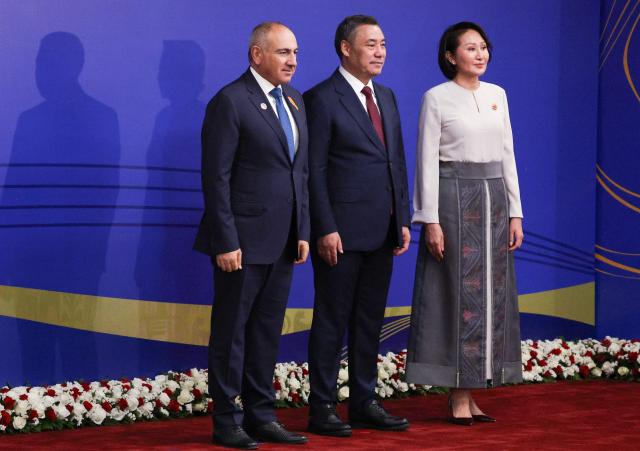 In this pool photograph distributed by the Russian state agency Sputnik, Armenian Prime Minister Nikol Pashinyan poses with Kyrgyzstan's President Sadyr Japarov and first lady Aigul prior to the opening ceremony of the 6th World Nomad Games at the Bishkek Arena in Bishkek on August 31, 2026. (Photo by Vyacheslav PROKOFYEV / POOL / AFP)