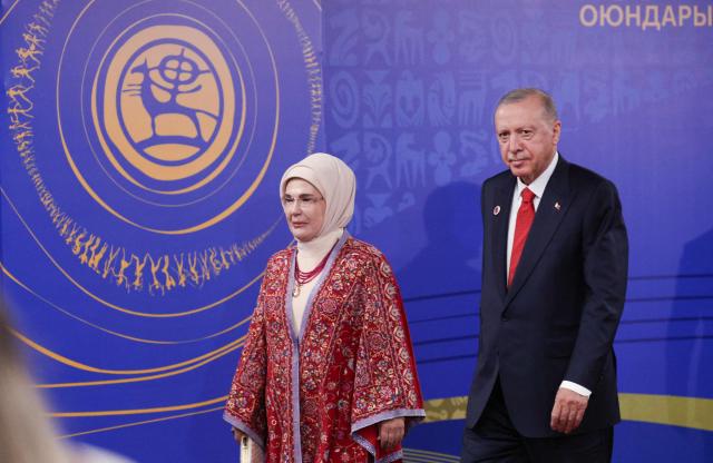 In this pool photograph distributed by the Russian state agency Sputnik, Turkey's President Recep Tayyip Erdogan and his wife Emine Erdogan arrive to attend the opening ceremony of the 6th World Nomad Games at the Bishkek Arena in Bishkek on August 31, 2026. (Photo by Vyacheslav PROKOFYEV / POOL / AFP)