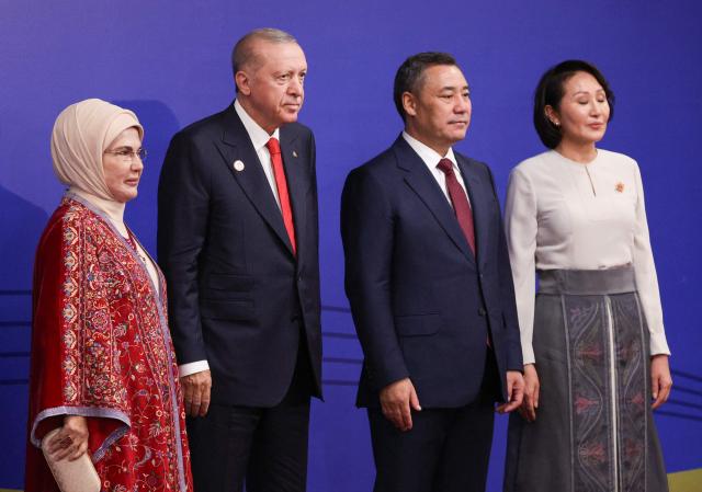 In this pool photograph distributed by the Russian state agency Sputnik, Turkey's President Recep Tayyip Erdogan and his wife Emine Erdogan pose with Kyrgyzstan's President Sadyr Japarov and first lady Aigul prior to the opening ceremony of the 6th World Nomad Games at the Bishkek Arena in Bishkek on August 31, 2026. (Photo by Vyacheslav PROKOFYEV / POOL / AFP)