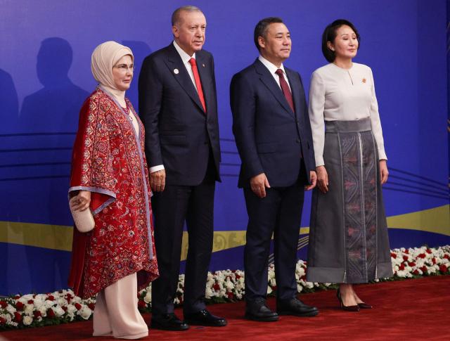 In this pool photograph distributed by the Russian state agency Sputnik, Turkey's President Recep Tayyip Erdogan and his wife Emine Erdogan pose with Kyrgyzstan's President Sadyr Japarov and first lady Aigul prior to the opening ceremony of the 6th World Nomad Games at the Bishkek Arena in Bishkek on August 31, 2026. (Photo by Vyacheslav PROKOFYEV / POOL / AFP)