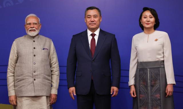 In this pool photograph distributed by the Russian state agency Sputnik, Indian Prime Minister Narendra Modi poses with Kyrgyzstan's President Sadyr Japarov and first lady Aigul prior to the opening ceremony of the 6th World Nomad Games at the Bishkek Arena in Bishkek on August 31, 2026. (Photo by Peter KOVALEV / POOL / AFP)