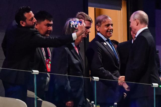 Russia's President Vladimir Putin and Pakistan's Prime Minister Shehbaz Sharif shake hands during the opening ceremony of the World Nomad Games at the Bishkek Arena in Bishkek on August 31, 2026. (Photo by Vyacheslav OSELEDKO / AFP)