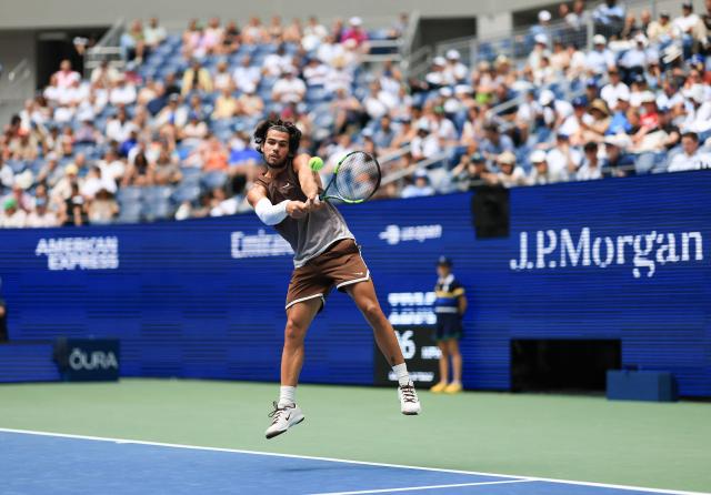 Spain's Carlos Alcaraz hits a return to Russia's Roman Safiullin during their men's singles first round tennis match on day two of the US Open tennis tournament at the USTA Billie Jean King National Tennis Center in New York City on August 31, 2026. (Photo by TIMOTHY A. CLARY / AFP)