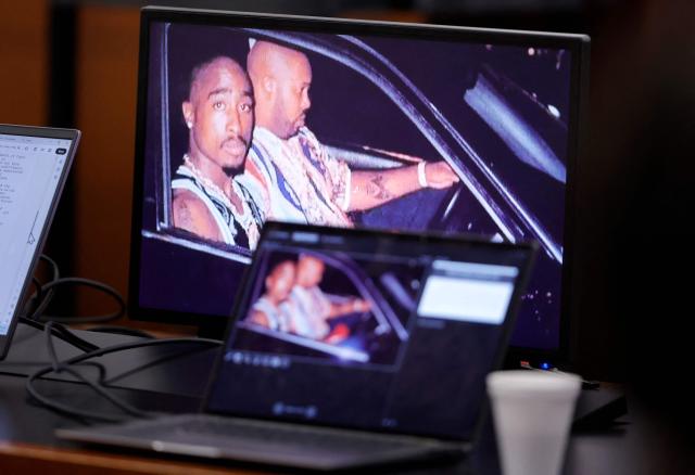 A 1996 photo of rapper Tupac Shakur (L) and Marion “Suge” Knight is shown on screens during closing arguments in the Duane Davis murder trial, related to the 1996 killing of rapper Tupac Shakur, at Clark County District Court at the Regional Justice Center in Las Vegas, Nevada, on August 31, 2026. The trial of the former gang leader accused of orchestrating the murder of rapper Tupac Shakur began on August 10, 30 years after one of America's most high-profile unresolved killings. The proceedings, expected to last a month, will likely not make clear who fired the shots that killed the California hip-hop legend on the night of September 7, 1996, while he was in Las Vegas to see a Mike Tyson boxing match. (Photo by STEVE MARCUS / POOL / AFP)