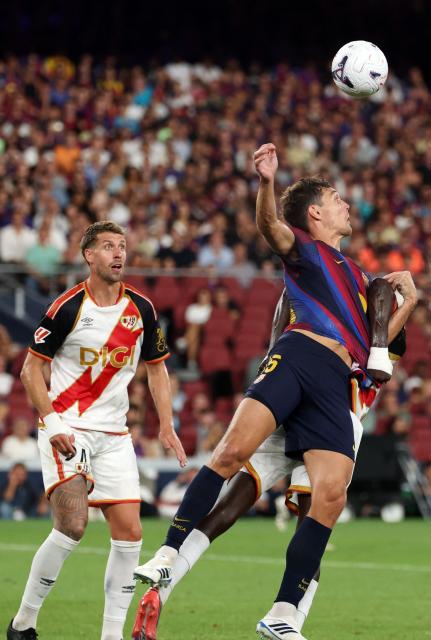 Barcelona's Danish defender #15 Andreas Christensen (2R) and Rayo Vallecano's Spanish midfielder #36 Gnangoro Bouare Samake (R) fight for the ball during the Spanish league football match between FC Barcelona and Rayo Vallecano de Madrid at Camp Nou Stadium in Barcelona on August 31, 2026. (Photo by Lluis GENE / AFP)