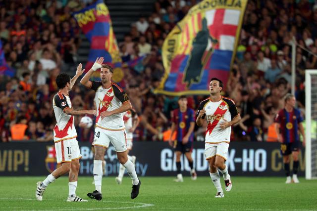 Rayo Vallecano's Spanish forward #10 Sergio Camello (L) celebrates his second goal during the Spanish league football match between FC Barcelona and Rayo Vallecano de Madrid at Camp Nou Stadium in Barcelona on August 31, 2026. (Photo by Lluis GENE / AFP)