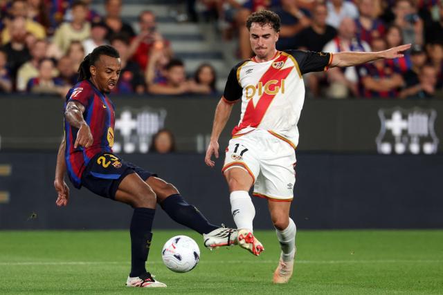Barcelona's French defender #23 Jules Kounde and Rayo Vallecano's Spanish defender #17 Adria Pedrosa fight for the ball during the Spanish league football match between FC Barcelona and Rayo Vallecano de Madrid at Camp Nou Stadium in Barcelona on August 31, 2026. (Photo by Lluis GENE / AFP)
