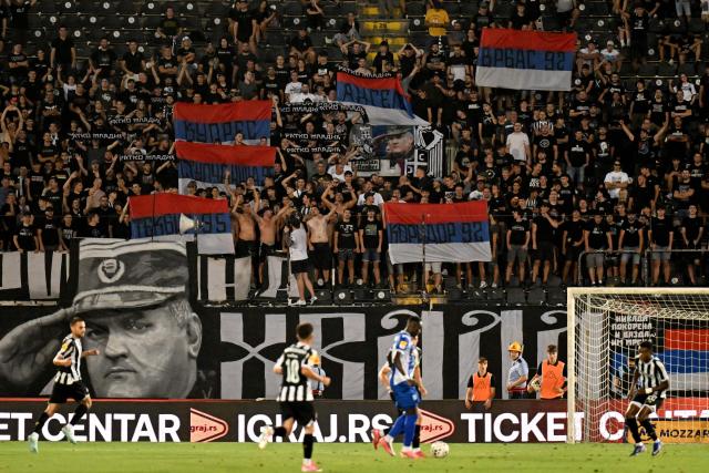 Partizan Belgrade supporters display a banner depicting former Bosnian Serb military chief Ratko Mladic during the Serbian SuperLiga football match between Partizan Belgrade and OFK Beograd in Belgrade on August 31, 2026, days after Mladic died at the age of 84 in a hospital in The Hague. Ratko Mladic, the former Bosnian Serb military chief dubbed the "Butcher of Bosnia" for his role in the 1995 Srebrenica massacre, has died, Serbian state broadcaster RTS reported on August 27, 2026. (Photo by OLIVER BUNIC / AFP)