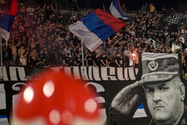 Partizan Belgrade supporters display a banner depicting former Bosnian Serb military chief Ratko Mladic during the Serbian SuperLiga football match between Partizan Belgrade and OFK Beograd in Belgrade on August 31, 2026, days after Mladic died at the age of 84 in a hospital in The Hague. Ratko Mladic, the former Bosnian Serb military chief dubbed the "Butcher of Bosnia" for his role in the 1995 Srebrenica massacre, has died, Serbian state broadcaster RTS reported on August 27, 2026. (Photo by OLIVER BUNIC / AFP)