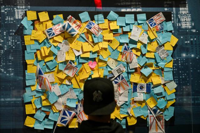 A member of the media views an exhibit at a press preview of the 9/11 Memorial & Museum’s exhibition, “In Their Honor: 25 Years of 9/11 Inspired Service”, exploring the legacy of service inspired by September 11, 2001, in New York, on August 31, 2026. September 11, 2026 will mark the 25th anniversary of the September 11, 2001 attacks. (Photo by ANGELA WEISS / AFP)