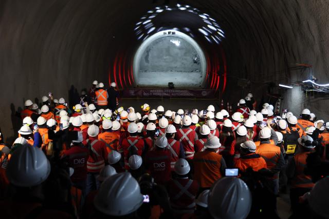 Workers watch the tunnel meeting for the expansion of Santiago Metro Line 6 in Santiago on August 31, 2026. (Photo by Javier TORRES / AFP)