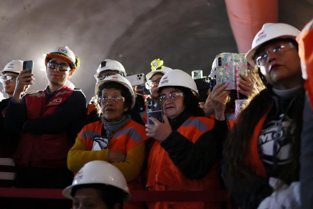 Workers watch the tunnel meeting for the expansion of Santiago Metro Line 6 in Santiago on August 31, 2026. (Photo by Javier TORRES / AFP)