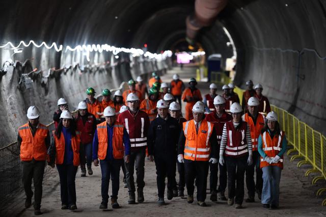 Chile's Transport Minister Louis de Grange (C) walks at the tunnel meeting construction site for the expansion of Santiago Metro Line 6 in Santiago on August 31, 2026. (Photo by Javier TORRES / AFP)