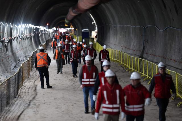 Workers walk at the tunnel meeting construction site for the expansion of Santiago Metro Line 6 in Santiago on August 31, 2026. (Photo by Javier TORRES / AFP)