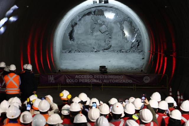 Workers watch the tunnel meeting for the expansion of Santiago Metro Line 6 in Santiago on August 31, 2026. (Photo by Javier TORRES / AFP)