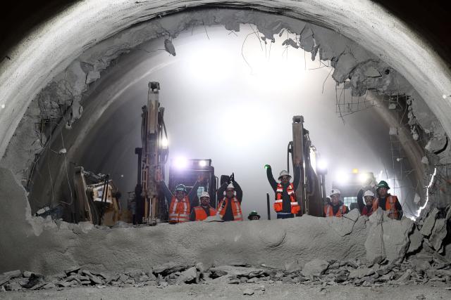 Workers celebrate the tunnel meeting at the construction site for the expansion of Santiago Metro Line 6 in Santiago on August 31, 2026. (Photo by Javier TORRES / AFP)