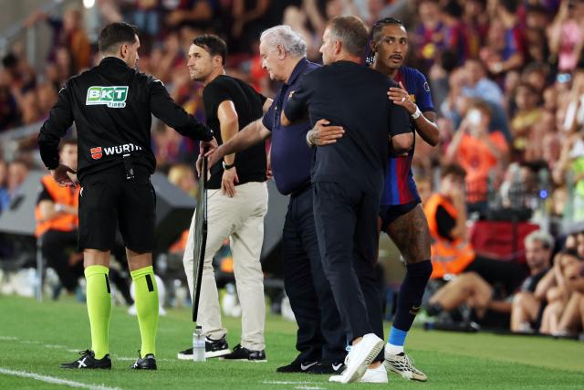 Barcelona's Brazilian forward #11 Raphinha (R) is hugged by Barcelona's German coach Hans-Dieter Flick after being substituted during the Spanish league football match between FC Barcelona and Rayo Vallecano de Madrid at Camp Nou Stadium in Barcelona on August 31, 2026. (Photo by Lluis GENE / AFP)