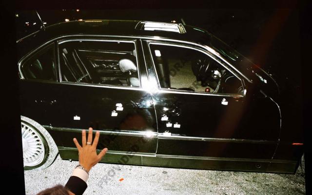 A 1996 photo of the bullet-ridden black BMW, that Marion “Suge” Knight and Tupac Shakur were riding in, is displayed as Michael Sanft, defense attorney for Duane Davis, makes closing arguments in the Duane Davis murder trial, related to the 1996 killing of rapper Tupac Shakur, at Clark County District Court at the Regional Justice Center in Las Vegas, Nevada, on August 31, 2026. The trial of the former gang leader accused of orchestrating the murder of rapper Tupac Shakur began on August 10, 30 years after one of America's most high-profile unresolved killings. The proceedings, expected to last a month, will likely not make clear who fired the shots that killed the California hip-hop legend on the night of September 7, 1996, while he was in Las Vegas to see a Mike Tyson boxing match. (Photo by STEVE MARCUS / POOL / AFP)