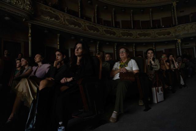 Spectators watch "Odyssey. Maeotis", a theatrical adaptation of Homer’s "Odyssey" by Ukraine’s Azov military corps, at the Ivan Franko Theatre in Kyiv on August 28, 2026, amid the Russian invasion of Ukraine. The longing for home at the heart of Homer's Odyssey resonates in Ukraine, where Russia's invasion has displaced millions and sent hundreds of thousands to fight, with tens of thousands still missing or held captive.  While the epic has found audiences worldwide with Christopher Nolan's blockbuster, Kyiv has staged its adaptation: a collaboration between the Ivan Franko Theatre and the Azov military corps. (Photo by Serhii Okunev / AFP)
