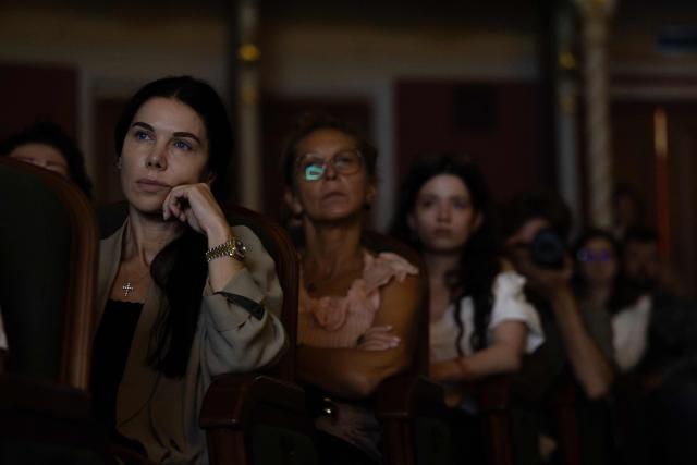 Spectators watch "Odyssey. Maeotis", a theatrical adaptation of Homer’s "Odyssey" by Ukraine’s Azov military corps, at the Ivan Franko Theatre in Kyiv on August 28, 2026, amid the Russian invasion of Ukraine. The longing for home at the heart of Homer's Odyssey resonates in Ukraine, where Russia's invasion has displaced millions and sent hundreds of thousands to fight, with tens of thousands still missing or held captive.  While the epic has found audiences worldwide with Christopher Nolan's blockbuster, Kyiv has staged its adaptation: a collaboration between the Ivan Franko Theatre and the Azov military corps. (Photo by Serhii Okunev / AFP)