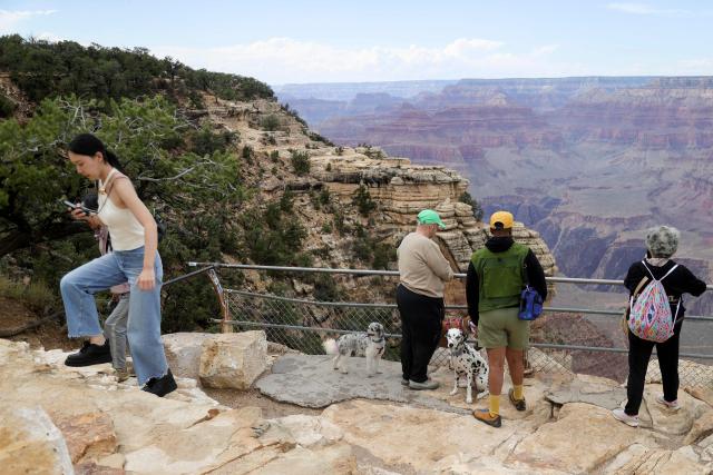 Visitors gather at a scenic overlook of the Grand Canyon, in Grand Canyon Village, Arizona, on August 31, 2026. More than 20 people may be missing after the flash flood in Grand Canyon National Park according to the National Park Service. The floods hit the Bright Angel Canyon and Phantom Ranch area on Saturday, the service said, adding that it was working with Arizona authorities to evacuate people and account for individuals in the affected area. (Photo by Ian Maule / AFP)
