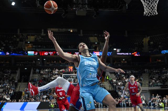 Uruguay's Pablo Gomez looks at the ball past Puerto Rico's Ismael Romero (back) during the FIBA Basketball World Cup 2027 Americas qualifiers Group F match between Uruguay and Puerto Rico at the Antel Arena stadium in Montevideo on August 31, 2026. (Photo by EITAN ABRAMOVICH / AFP)