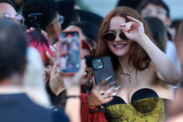 US actress Joey King takes selfies with fans as she attends the US premiere of "Practical Magic 2" at Directors Village theatre in Los Angeles, on August 31, 2026. (Photo by VALERIE MACON / AFP)