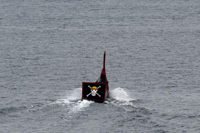 A fishing boat with its stern bearing the logo of popular Japanese manga One Piece, a symbol adopted by Gen Z protest movements worldwide, heads out to sea from Banda Aceh on September 1, 2026. (Photo by CHAIDEER MAHYUDDIN / AFP)
