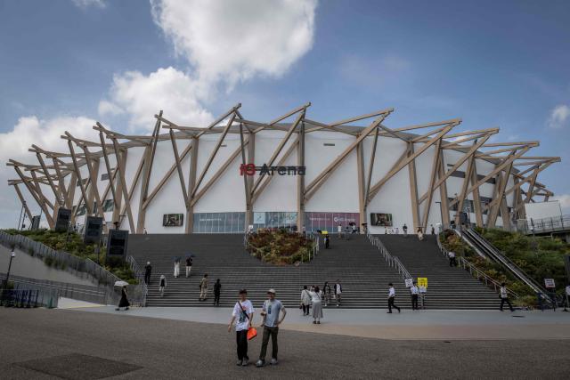 (FILES) This picture taken on September 7, 2025 shows people walking past the Aichi International Arena, the venue for basketball competitions in the upcoming 2026 Aichi-Nagoya Asian Games in Nagoya, Aichi prefecture. (Photo by Yuichi YAMAZAKI / AFP)