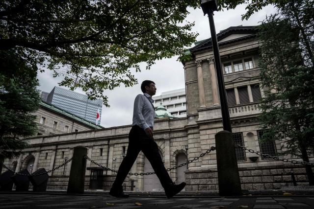 A man walks past the Bank of Japan (BoJ) headquarters in Tokyo on September 1, 2026. (Photo by Yuichi YAMAZAKI / AFP)
