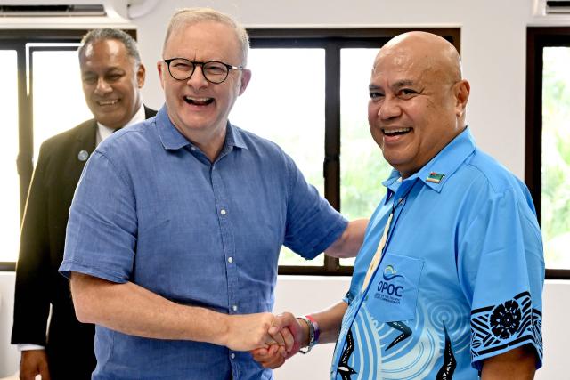 Australia's Prime Minister Anthony Albanese (C) shakes hands with Tuvalu's Prime Minister Feleti Teo (R) as Fiji's Minister for Foreign Affairs Sakiasi Ditoka (L) looks on at the start of a trilateral meeting during the 55th Pacific Islands Forum Leaders Meeting in Koror on September 1, 2026. (Photo by SAEED KHAN / AFP)
