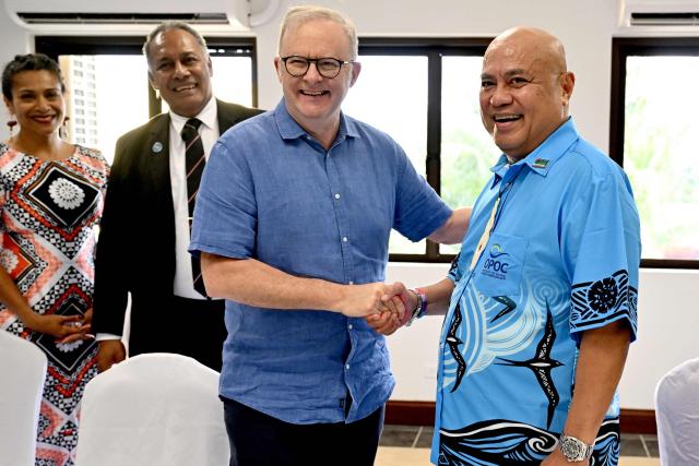 Australia's Prime Minister Anthony Albanese (C) shakes hands with Tuvalu's Prime Minister Feleti Teo (R) as Fiji's Minister for Foreign Affairs Sakiasi Ditoka (2nd L) looks on at the start of a trilateral meeting during the 55th Pacific Islands Forum Leaders Meeting in Koror on September 1, 2026. (Photo by SAEED KHAN / AFP)