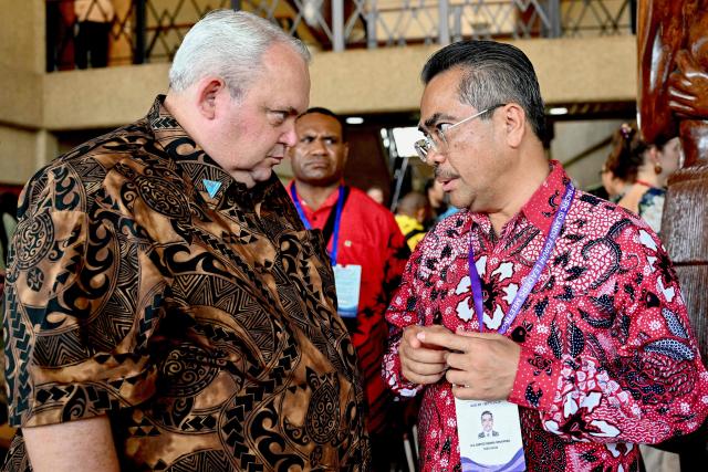 Papua New Guinea's Foreign Minister Justin Tkatchenko (L) meets Dupito Darma Simamora, Indonesia's Ambassador to Fiji, Kiribati, Nauru, and Tuvalu, during the 55th Pacific Islands Forum Leaders Meeting in Koror on September 1, 2026. (Photo by SAEED KHAN / AFP)