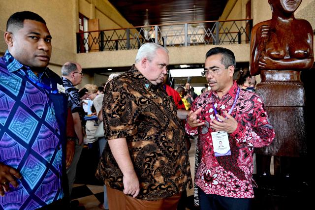 Papua New Guinea's Foreign Minister Justin Tkatchenko (C) meets Dupito Darma Simamora (R), Indonesia's Ambassador to Fiji, Kiribati, Nauru, and Tuvalu, during the 55th Pacific Islands Forum Leaders Meeting in Koror on September 1, 2026. (Photo by SAEED KHAN / AFP)
