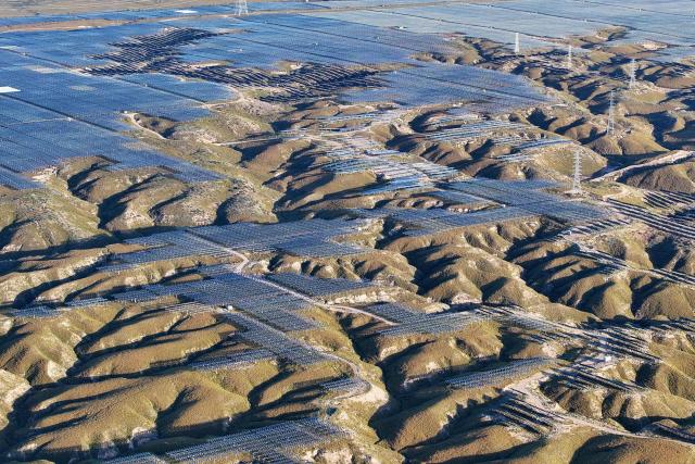 (FILES) Solar panels are seen on hilltops at the Yinchuan Fourth Photovoltaic Power Station in Yinchuan, in China’s northern Ningxia region on September 24, 2025. China's installed solar energy capacity has surpassed that of coal-fired power for the first time, the national energy body said on September 1, 2026, hailing the milestone. (Photo by CN-STR / AFP) / China OUT