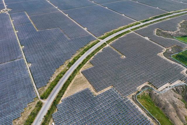 (FILES) An aerial view of solar panels at the Yinchuan Fourth Photovoltaic Power Station in Yinchuan, in northwestern China's Ningxia Hui Autonomous Region, on August 25, 2026. China's installed solar energy capacity has surpassed that of coal-fired power for the first time, the national energy body said on September 1, 2026, hailing the milestone. (Photo by CN-STR / AFP) / China OUT