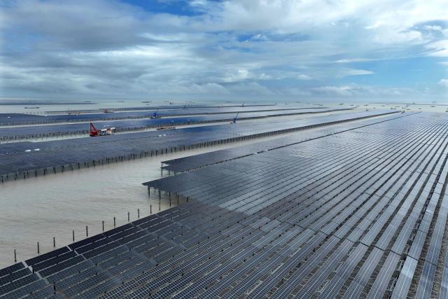 This picture taken on August 23, 2026 shows the construction site of the CNNC Tianwan 2-million-kilowatt tidal flat photovoltaic demonstration project in Lianyungang, in eastern China's Jiangsu province. China's installed solar energy capacity has surpassed that of coal-fired power for the first time, the national energy body said on September 1, 2026, hailing the milestone. (Photo by CN-STR / AFP) / China OUT