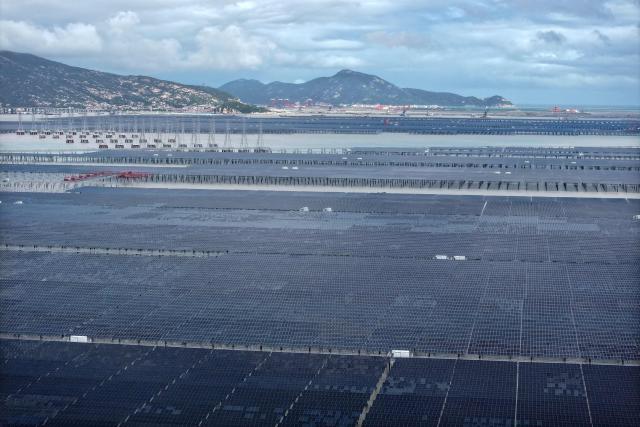 This picture taken on August 23, 2026 shows the construction site of the CNNC Tianwan 2-million-kilowatt tidal flat photovoltaic demonstration project in Lianyungang, in eastern China's Jiangsu province. China's installed solar energy capacity has surpassed that of coal-fired power for the first time, the national energy body said on September 1, 2026, hailing the milestone. (Photo by CN-STR / AFP) / China OUT