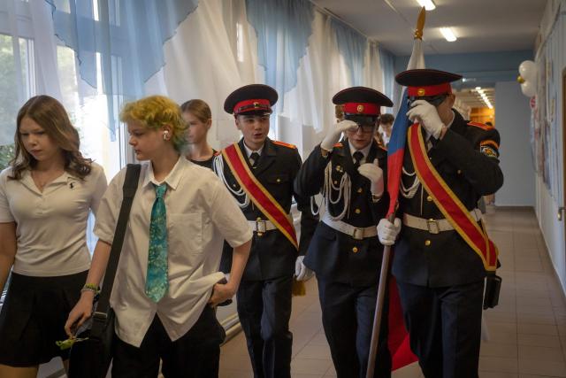 Teenagers and students of the cadet class walk along a corridor of a school on the first day of the school year in Moscow on September 1, 2026. (Photo by Andrey BORODULIN / AFP)