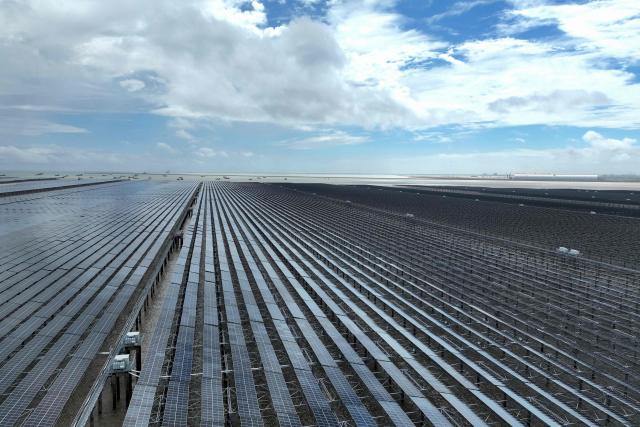 This picture taken on August 23, 2026 shows the construction site of the CNNC Tianwan 2-million-kilowatt tidal flat photovoltaic demonstration project in Lianyungang, in eastern China's Jiangsu province. China's installed solar energy capacity has surpassed that of coal-fired power for the first time, the national energy body said on September 1, 2026, hailing the milestone. (Photo by CN-STR / AFP) / China OUT