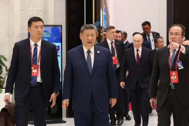 In this pool photograph distributed by the Russian state agency Sputnik, China's President Xi Jinping walks during the Shanghai Cooperation Organisation (SCO) summit in Bishkek on September 1, 2026. (Photo by Vyacheslav PROKOFYEV / POOL / AFP)